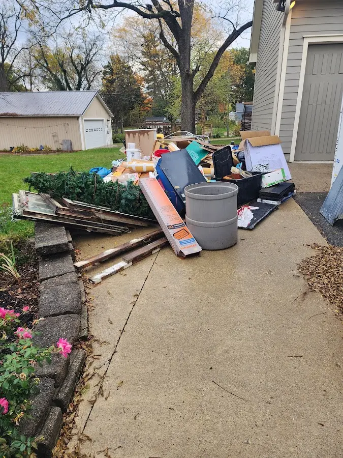 Dumpster being loaded with debris for 12 Yard Dumpster Rental in Winfield